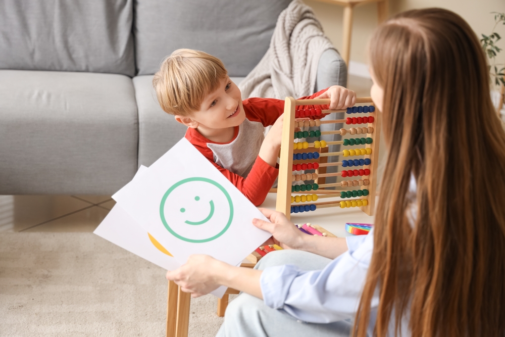 Little,boy,playing,with,abacus,at,psychologist's,office.,world,autism